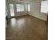 Cozy living room with tile floors, large windows, and a fireplace at 9839 Brook Canyon Dr, Las Vegas, NV 89147