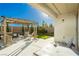 Outdoor patio with a pergola, seating area, and well-maintained landscaping at 9953 Fletcher Peak Ave, Las Vegas, NV 89178