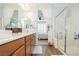 Bright bathroom with double sink vanity, glass shower and curtain to bedroom at 9953 Fletcher Peak Ave, Las Vegas, NV 89178