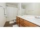 Well-lit bathroom with double sink vanity and shower/tub combo at 9953 Fletcher Peak Ave, Las Vegas, NV 89178