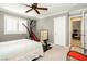 View of bedroom with exercise equipment, neutral carpet, and a peek into the en suite bathroom at 9953 Fletcher Peak Ave, Las Vegas, NV 89178