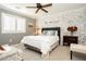 Comfortable bedroom with a ceiling fan, large window, and neutral tones creating a soothing atmosphere at 9953 Fletcher Peak Ave, Las Vegas, NV 89178