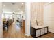 Inviting hallway with decorative wallpaper, a storage bench with cushions, and an open view into the dining and kitchen areas at 9953 Fletcher Peak Ave, Las Vegas, NV 89178