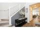 Elegant entryway featuring a staircase, console table with decor, and wood-look tile flooring, creating a welcoming ambiance at 9953 Fletcher Peak Ave, Las Vegas, NV 89178
