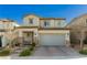 Charming two-story home with a two-car garage and meticulously paved driveway enhanced by stone accents and manicured landscaping at 9953 Fletcher Peak Ave, Las Vegas, NV 89178