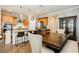 Open kitchen and dining area featuring an island with bar seating, stainless steel appliances, and ample counter space at 9953 Fletcher Peak Ave, Las Vegas, NV 89178