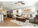 Open-concept living room with wood-look tile flooring, neutral walls, and plenty of natural light at 9953 Fletcher Peak Ave, Las Vegas, NV 89178