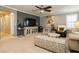 Living room featuring a ceiling fan and large TV, great for relaxing and entertaining at 9953 Fletcher Peak Ave, Las Vegas, NV 89178