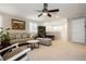 Spacious living room featuring neutral carpet, shutters and ceiling fan at 9953 Fletcher Peak Ave, Las Vegas, NV 89178