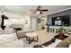 Open living room with neutral walls, carpet and large TV, perfect for entertaining at 9953 Fletcher Peak Ave, Las Vegas, NV 89178