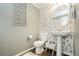 Stylish powder room features modern wallpaper, pedestal sink, and decorative accents at 9953 Fletcher Peak Ave, Las Vegas, NV 89178