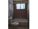 Cozy bathroom featuring a tub/shower combo, neutral tile, and a window for natural light at , North Las Vegas, NV 89030