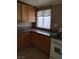 Functional kitchen with light wood cabinets, laminate countertops, a mosaic backsplash, and a white range at , North Las Vegas, NV 89030