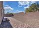 An expansive backyard with a brick-paved walkway, desert landscaping, and tall privacy walls at , North Las Vegas, NV 89031