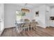 Dining room with a view to the backyard, decorative light fixture, and hardwood floors at , North Las Vegas, NV 89031