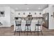 Kitchen island with bar seating, quartz counters, stainless appliances, and bright white cabinets at , North Las Vegas, NV 89031