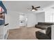 Spacious living room with a ceiling fan, dark leather sofas, and built in cabinets at , North Las Vegas, NV 89031