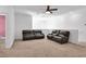 Spacious living room with two dark leather sofas and neutral carpet flooring at , North Las Vegas, NV 89031