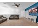 Spacious living room with a ceiling fan, dark leather sofas, and built in bookshelves and cabinets at , North Las Vegas, NV 89031