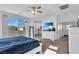 Bright main bedroom with a ceiling fan, a large window, and an ensuite bathroom area with vanity at , North Las Vegas, NV 89031