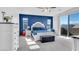 A bedroom featuring a royal blue accent wall and a sliding glass door to a private balcony at , North Las Vegas, NV 89031