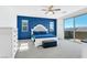 Bright bedroom boasts blue accent wall, carpeted floor, and sliding door to a balcony at , North Las Vegas, NV 89031