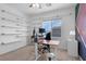 Bright office space with floating shelves, a modern desk, chair, and large window at , North Las Vegas, NV 89031