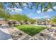 Community park with lush green grass, shaded picnic tables, desert landscaping, and walking paths at , North Las Vegas, NV 89031