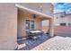 Covered patio with a ceiling fan, outdoor dining set, and a view of the desert-style landscaped backyard at , North Las Vegas, NV 89031