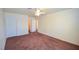 Spacious bedroom featuring neutral walls, ceiling fan, and carpeted flooring at 1000 Grammy Dr, Las Vegas, NV 89145