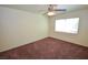 Bedroom featuring neutral walls, ceiling fan, a window, and carpeted flooring at 1000 Grammy Dr, Las Vegas, NV 89145