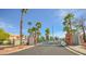 Community features secure gate access for residents, palm trees and well-manicured landscaping at 1000 Grammy Dr, Las Vegas, NV 89145