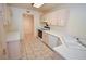 Well-lit kitchen showcasing tile flooring, plenty of cabinetry, and sleek appliances for culinary enthusiasts at 1000 Grammy Dr, Las Vegas, NV 89145