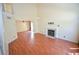 Inviting living room featuring a cozy fireplace, high ceilings, and beautiful hardwood floors at 1000 Grammy Dr, Las Vegas, NV 89145