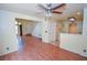 Open living room with hardwood floors, ceiling fan, and easy access to the kitchen and stairs at 1000 Grammy Dr, Las Vegas, NV 89145