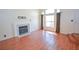Bright living room featuring a fireplace, wood-look floors, and large windows at 1000 Grammy Dr, Las Vegas, NV 89145
