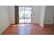 Sunny living room features a sliding glass door to the patio and hardwood floors at 1000 Grammy Dr, Las Vegas, NV 89145