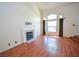 Bright living room featuring a cozy fireplace, large windows, and hardwood floors at 1000 Grammy Dr, Las Vegas, NV 89145
