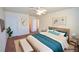 Staged main bedroom showcasing a stylish bed frame, bench, decor, and access to other rooms at 1000 Grammy Dr, Las Vegas, NV 89145