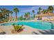 Relaxing community pool featuring ample seating and lush tropical landscaping in a secure gated community at 1000 Grammy Dr, Las Vegas, NV 89145