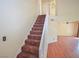 Carpeted staircase connects the different levels of the home with a bright and inviting atmosphere at 1000 Grammy Dr, Las Vegas, NV 89145