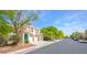 Charming townhome featuring an attached two-car garage, colorful desert landscaping and ample parking at 1000 Grammy Dr, Las Vegas, NV 89145