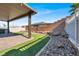 Backyard oasis with a covered patio, an outdoor kitchen, and a manicured lawn at 1024 Fishing St, Henderson, NV 89011