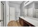 Bathroom features a long vanity with dual sinks, a walk-in shower, and tiled flooring at 1024 Fishing St, Henderson, NV 89011