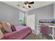 Bedroom with work space, featuring a comfortable bed, desk, and natural light at 1024 Fishing St, Henderson, NV 89011