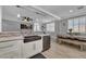 Kitchen with a stainless steel dishwasher and sink, and a view of the dining and living areas at 1024 Fishing St, Henderson, NV 89011