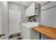 Functional laundry room with washer, dryer, overhead cabinets, and a folding counter at 1024 Fishing St, Henderson, NV 89011
