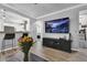 Comfortable living room, featuring a large TV, modern decor, and connection to the kitchen at 1024 Fishing St, Henderson, NV 89011