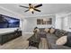 Comfortable living room featuring a large sectional sofa, ceiling fan, and modern decor at 1024 Fishing St, Henderson, NV 89011