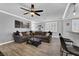 Open-concept living room with tile floors, a large sofa, and ample natural light at 1024 Fishing St, Henderson, NV 89011